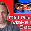 Man crying as he looks at a retro video game character